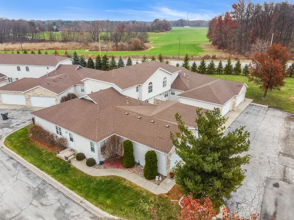 an aerial view of a house with garden space and lake view