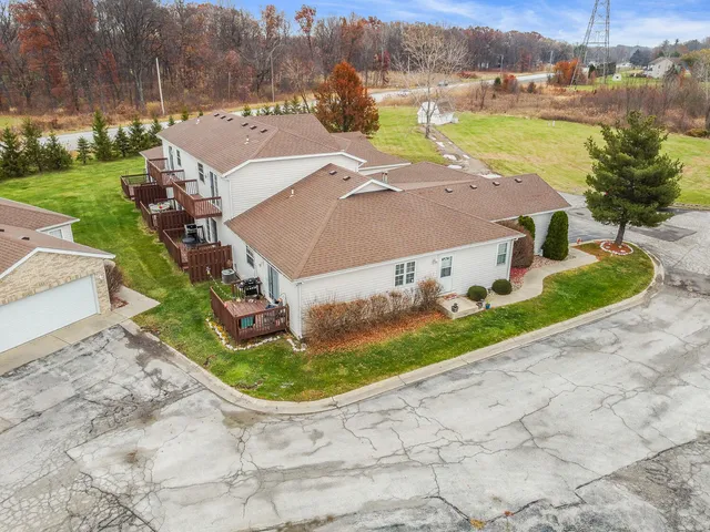 an aerial view of a house with a yard and lake view
