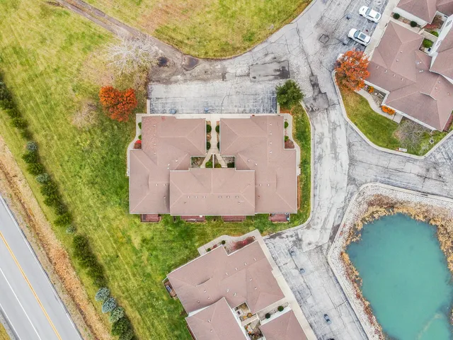 an aerial view of a house with a yard and trees