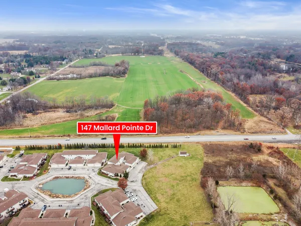 a view of a swimming pool with a yard and mountain view in back