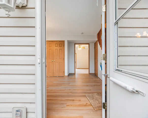 a view of an entryway with wooden floor