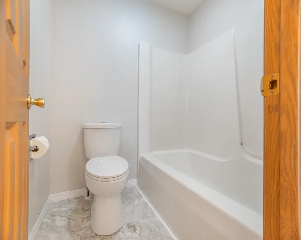 a bathroom with a toilet and a bathtub