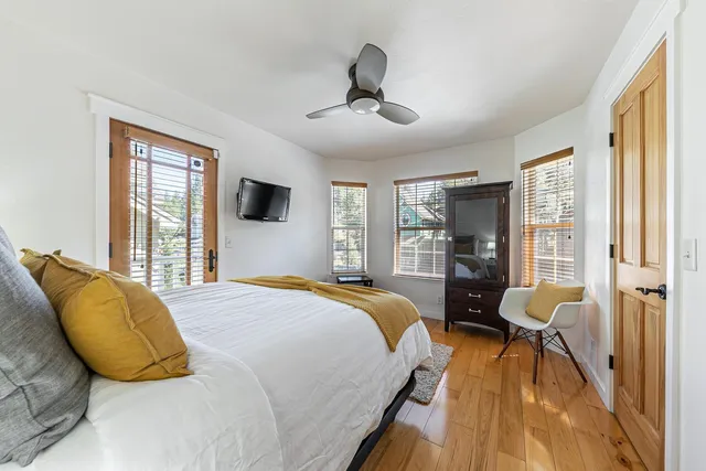 a spacious bedroom with a bed and a large window