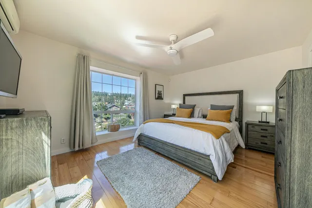 a bedroom with a bed and large window