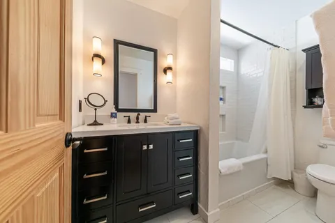 a bathroom with a sink a toilet and shower