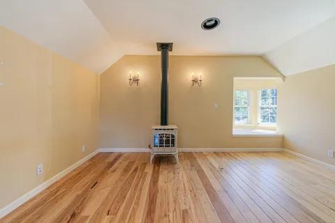 a view of a room with wooden floor and a window