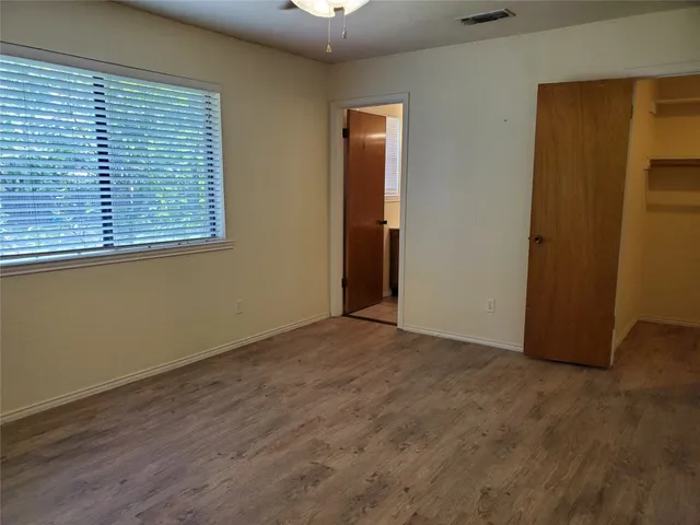 an empty room with windows and closet