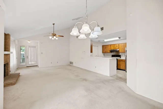 a kitchen with a sink stove top oven and cabinets