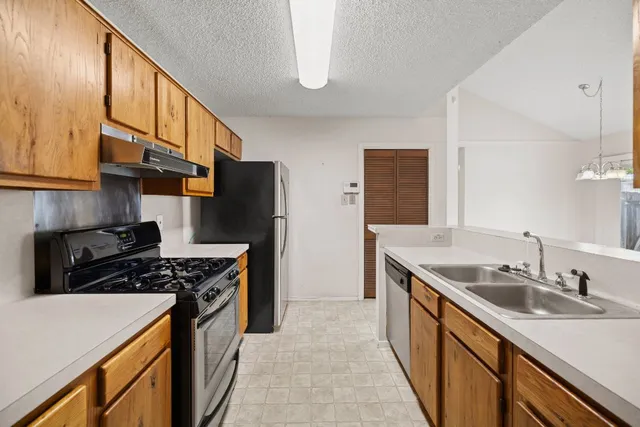 an empty room with closet and chandelier fan