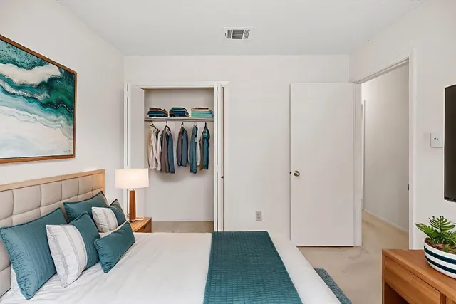 an empty room with chandelier fan