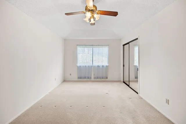 a view of a chandelier fan and window