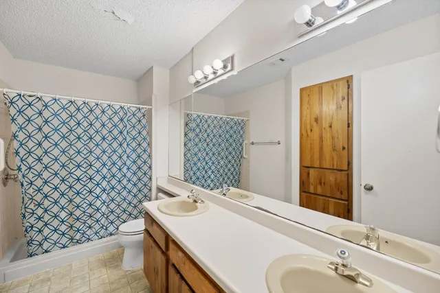 a bathroom with a shower curtain and a shower