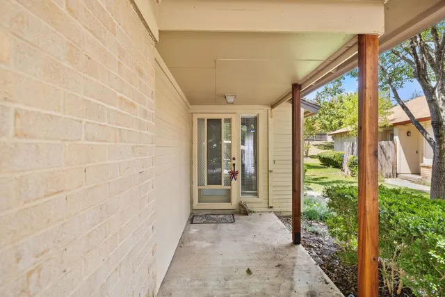 a view of a big room with chandelier fan and windows