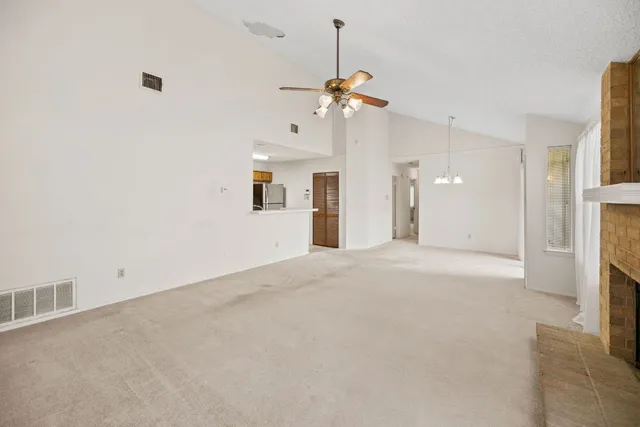 a view of an empty room with a fireplace