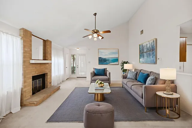 a view of a room with a fireplace cabinet and windows
