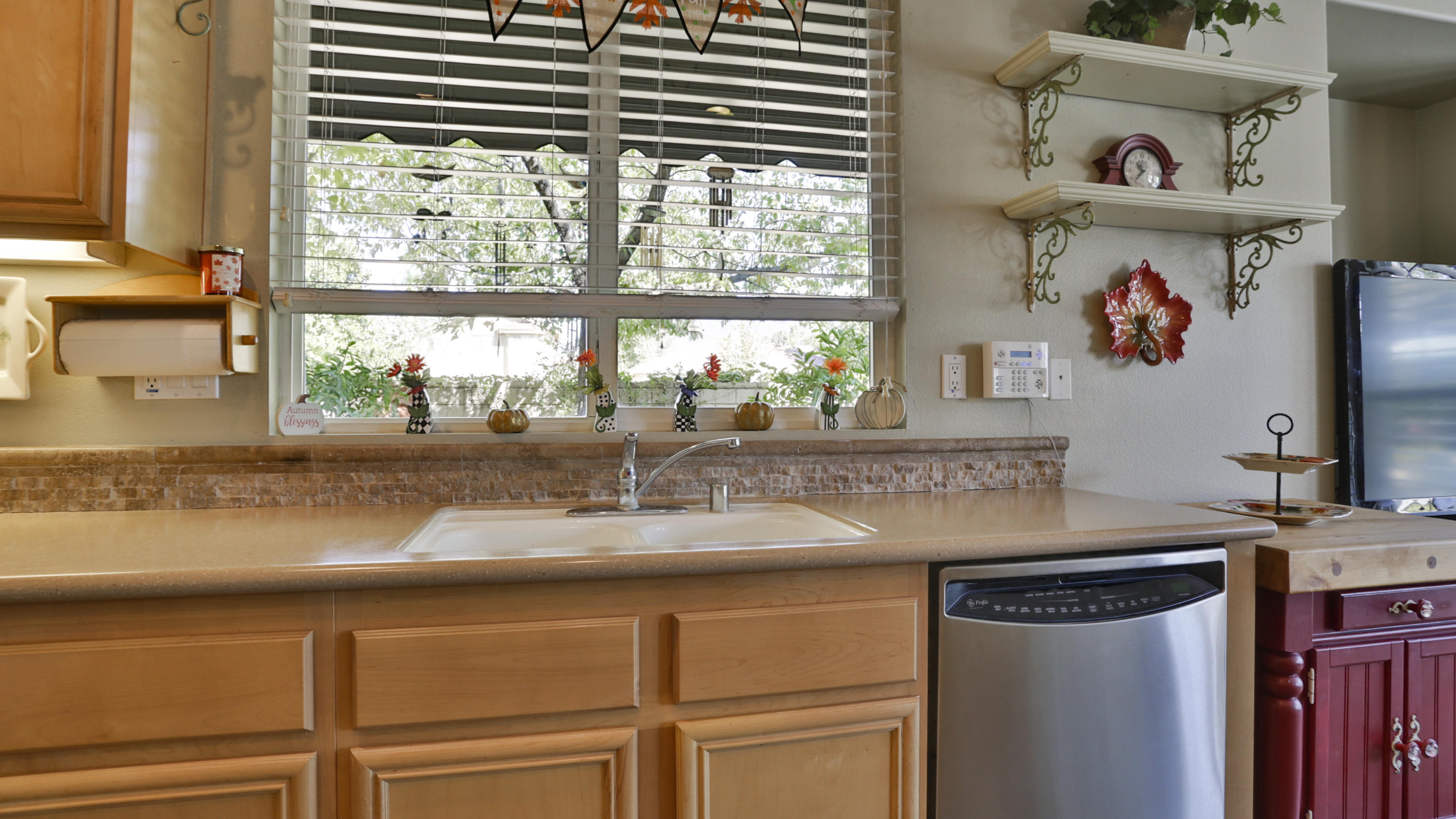 1598 Thunderbird Road Beaumont, CA 92223 - Photo 11 of 52 a kitchen with kitchen island a large window a sink and cabinets