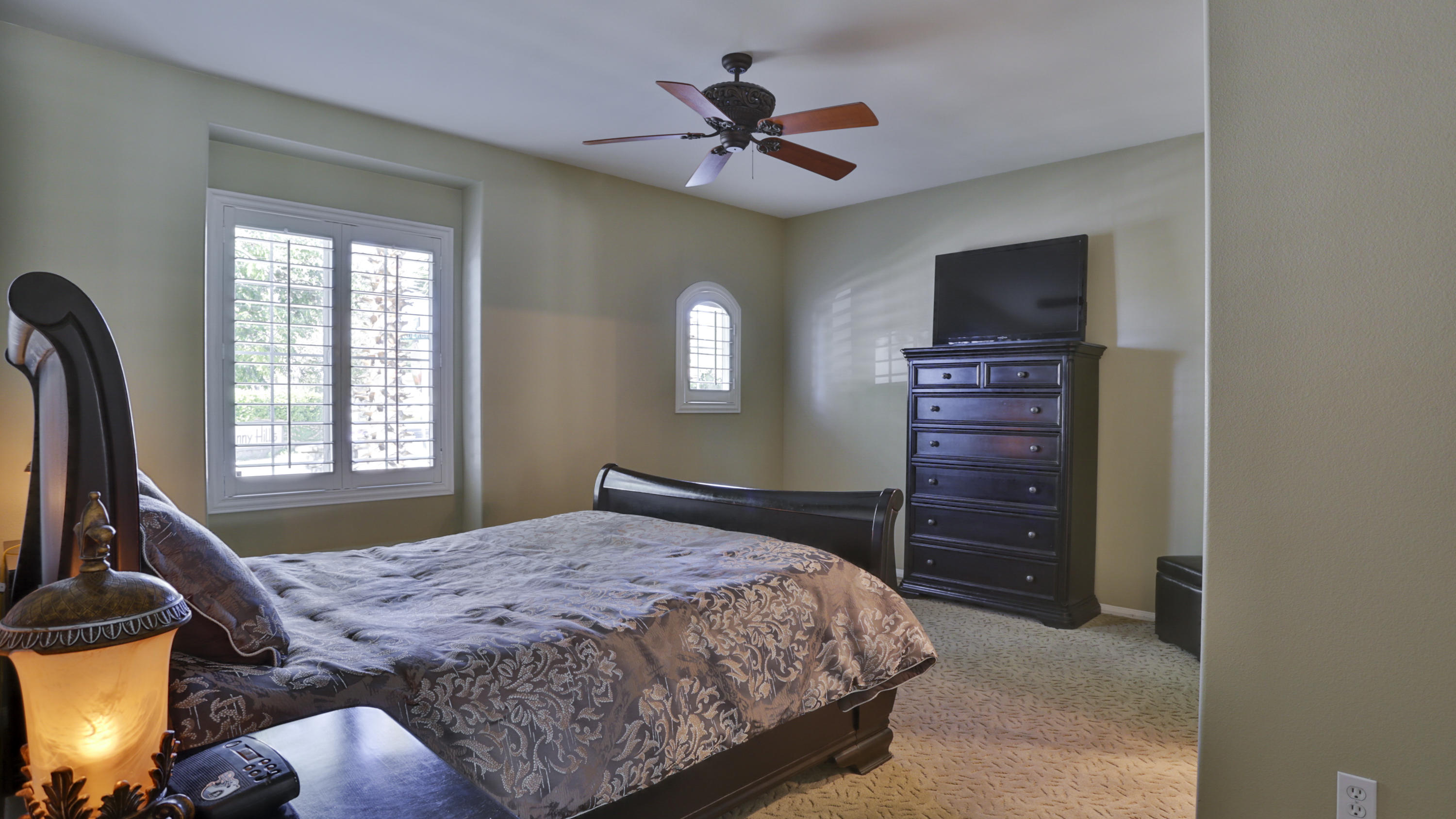 1598 Thunderbird Road Beaumont, CA 92223 - Photo 23 of 52 a bedroom with a bed and a chandelier