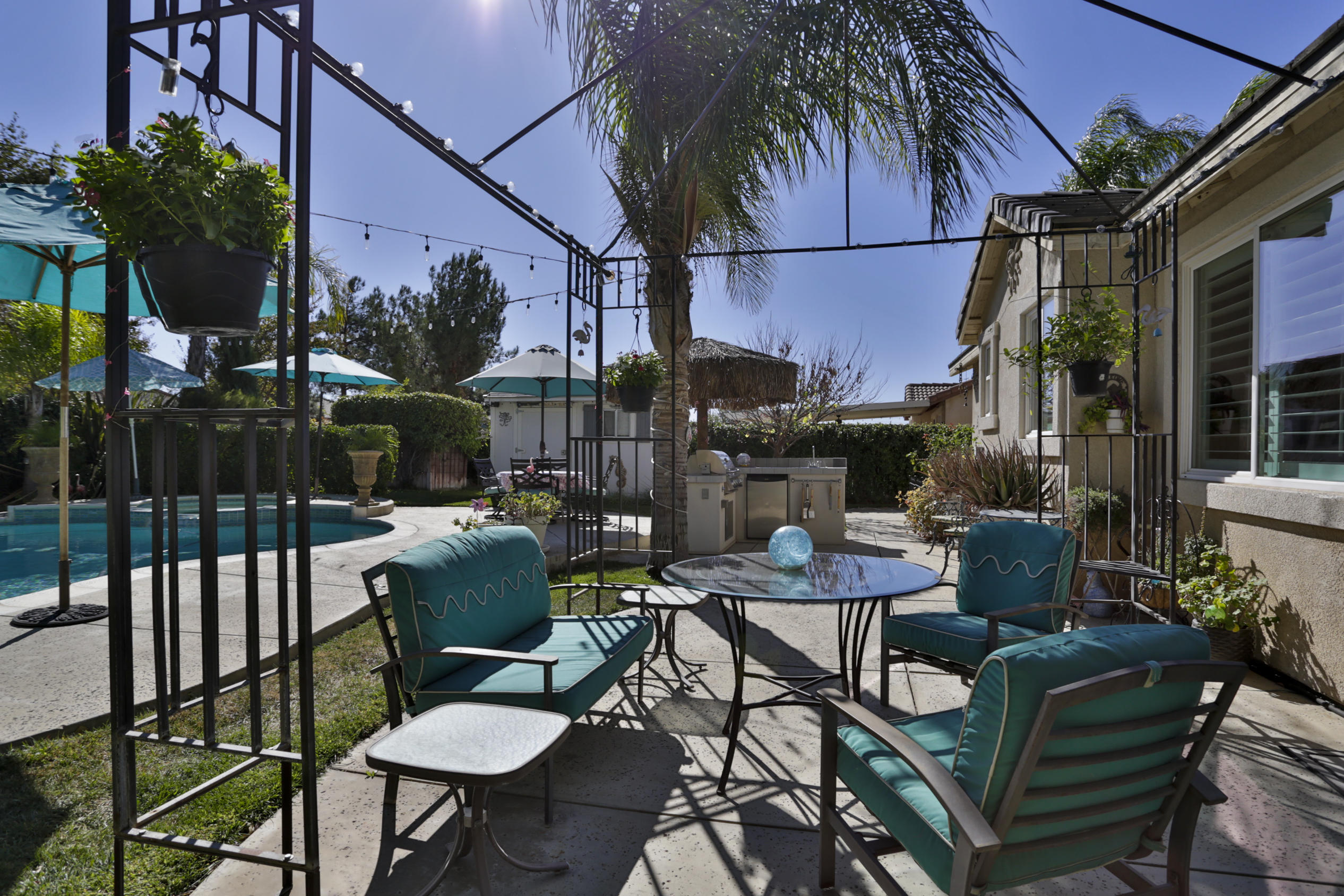 1598 Thunderbird Road Beaumont, CA 92223 - Photo 42 of 52 a view of a patio with a dining table and chairs with a fire pit