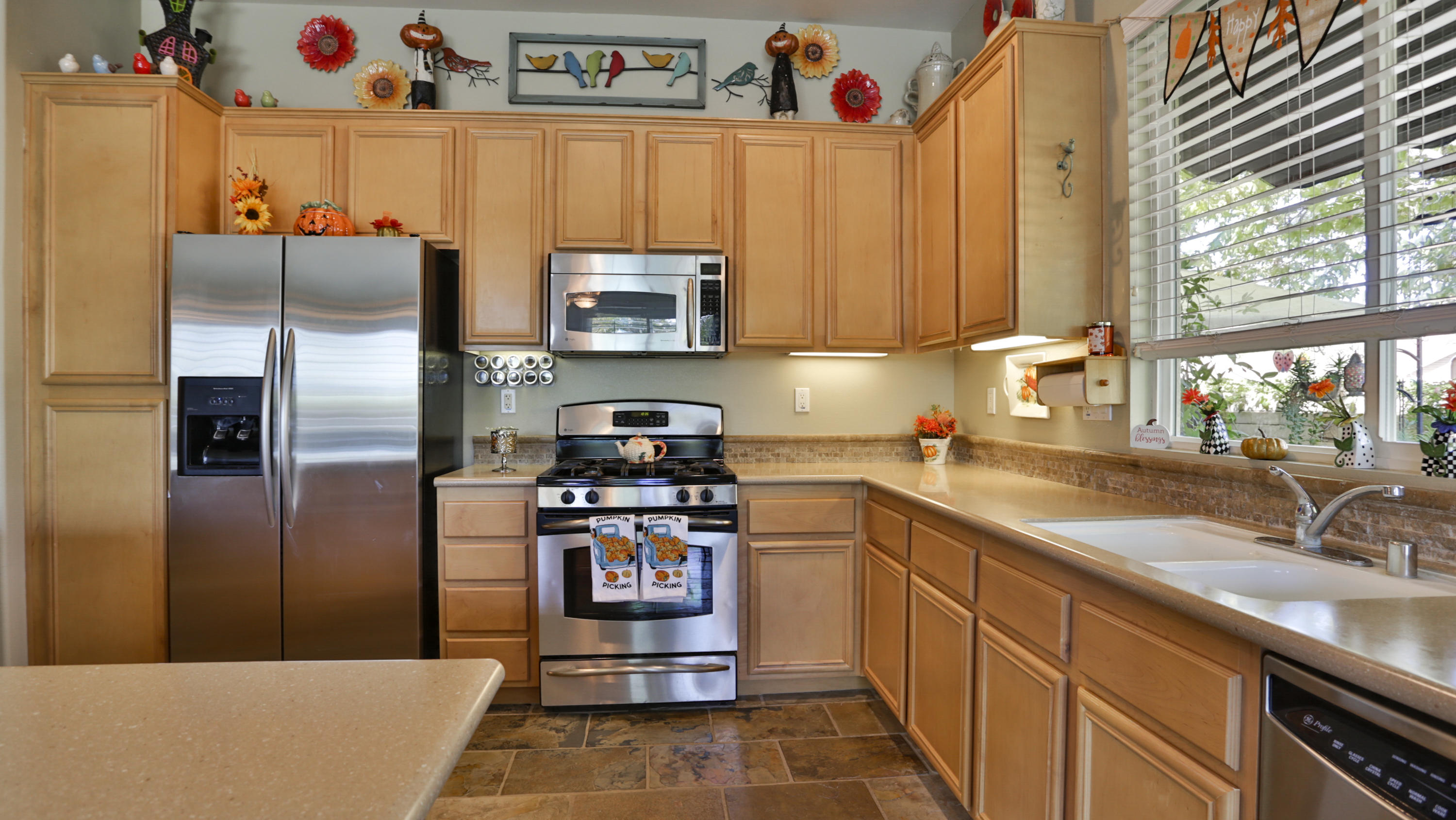 1598 Thunderbird Road Beaumont, CA 92223 - Photo 10 of 52 a kitchen with stainless steel appliances a refrigerator a sink a stove and a refrigerator