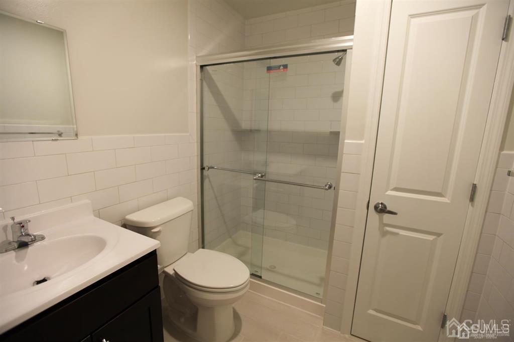 3301 Hana Road Edison, NJ 08817 - Photo 16 of 39 a bathroom with a shower toilet and sink