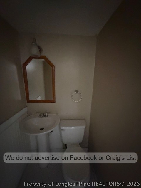 6471 Yadkin Road, Unit 17 Fayetteville, NC 28303 - Photo 4 of 9 a bathroom with a toilet and a sink