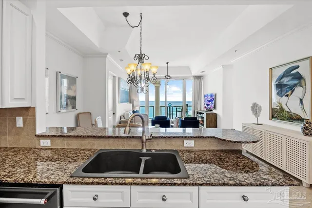 a kitchen with sink and chandelier