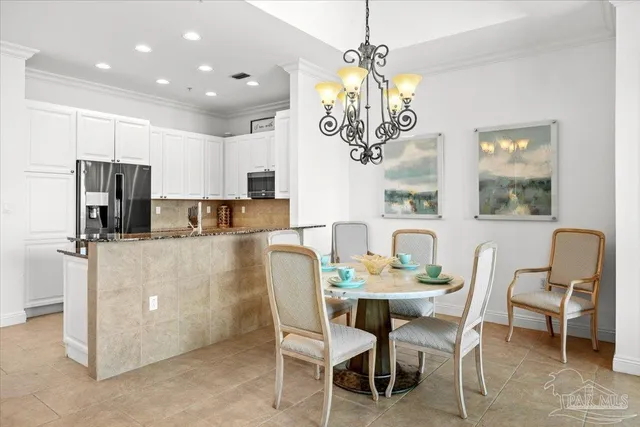 a view of a dining room with furniture and chandelier