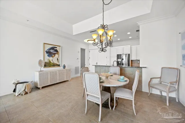 a view of a dining room with furniture and chandelier