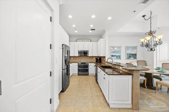 a kitchen with stainless steel appliances granite countertop a sink and cabinets