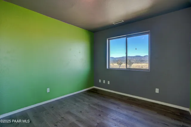 a view of a room with wooden floor and windows