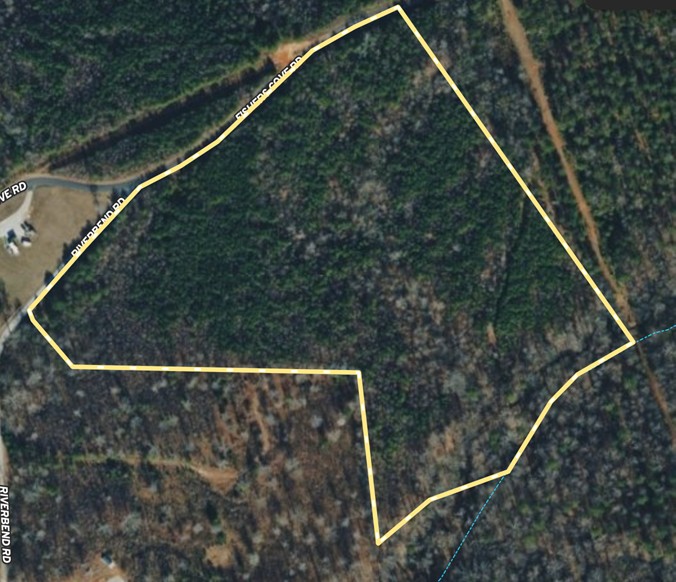 A detailed plat map outlines the expansive boundaries of this wooded property.
