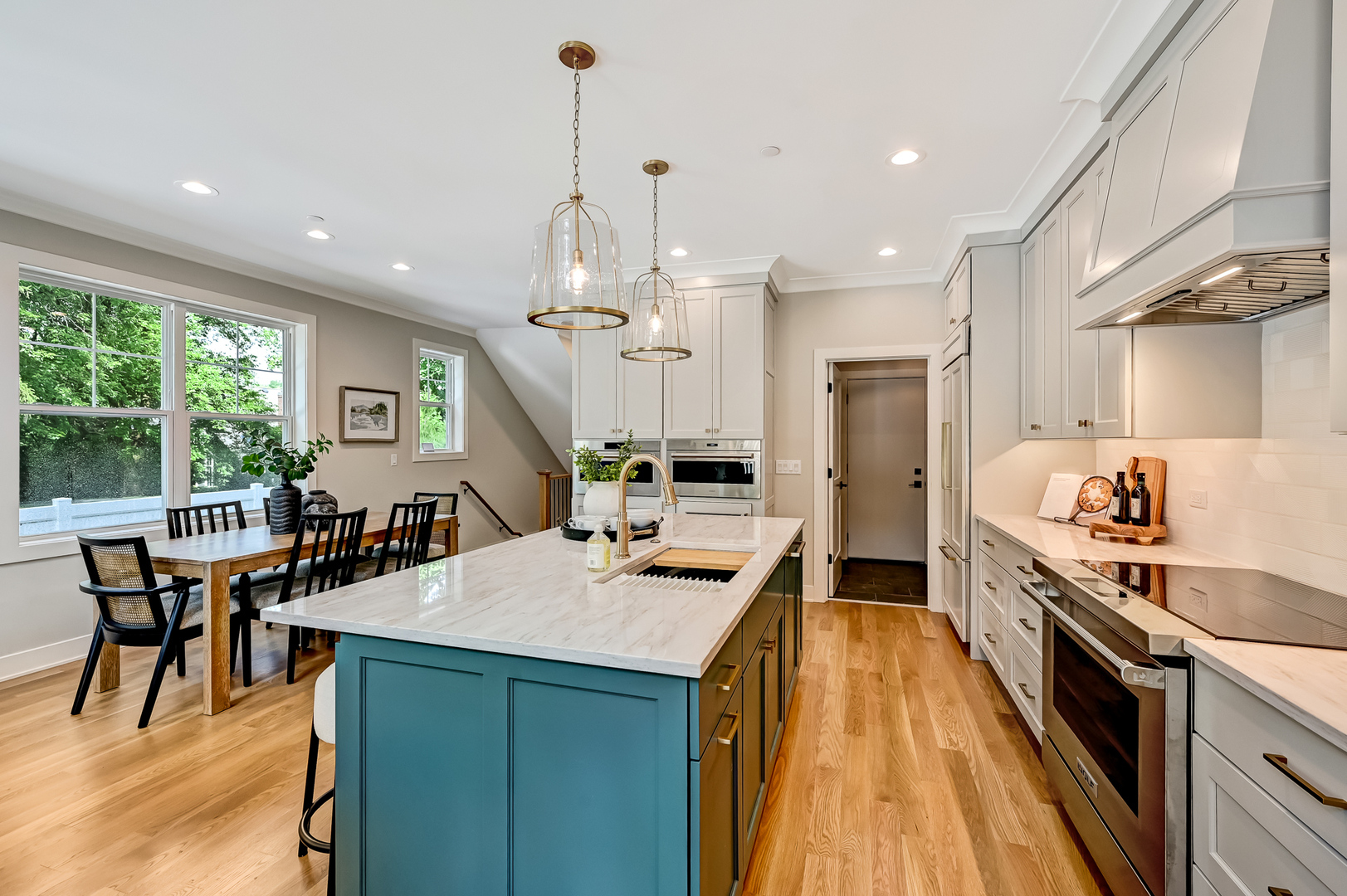 143 Harding Avenue Glen Ellyn, IL 60137 - Photo 9 of 40 a kitchen with kitchen island a large counter top space a sink stainless steel appliances and cabinets