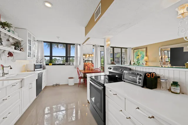 a kitchen with cabinets a sink and appliances