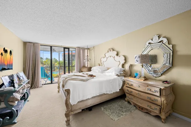 a spacious bedroom with a bed and a window