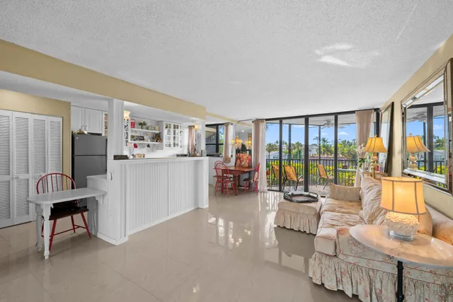a living room with furniture and a floor to ceiling window