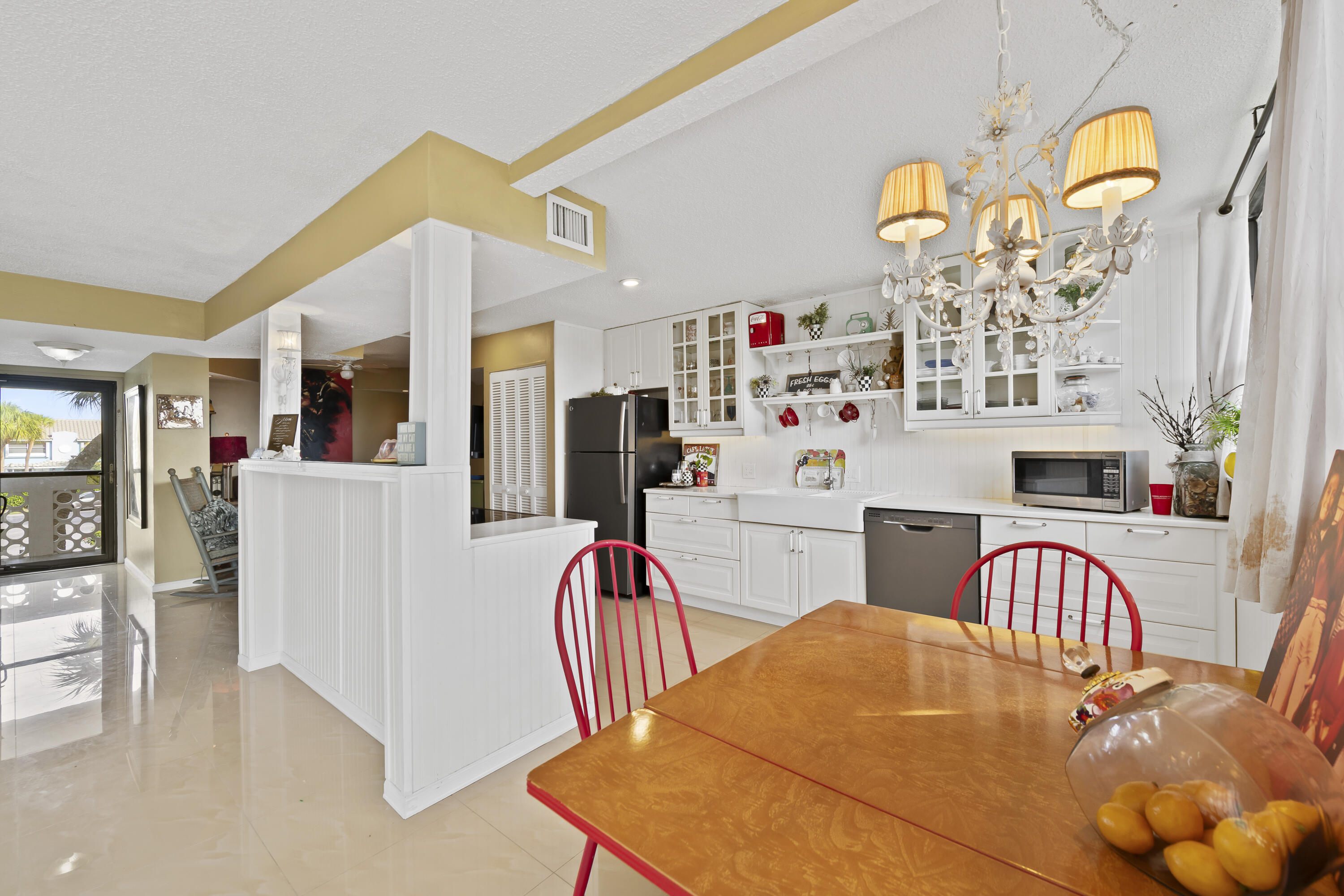 800 Jeffery Street, Unit 204 Boca Raton, FL 33487 - Photo 6 of 36 a dining room with furniture and chandelier