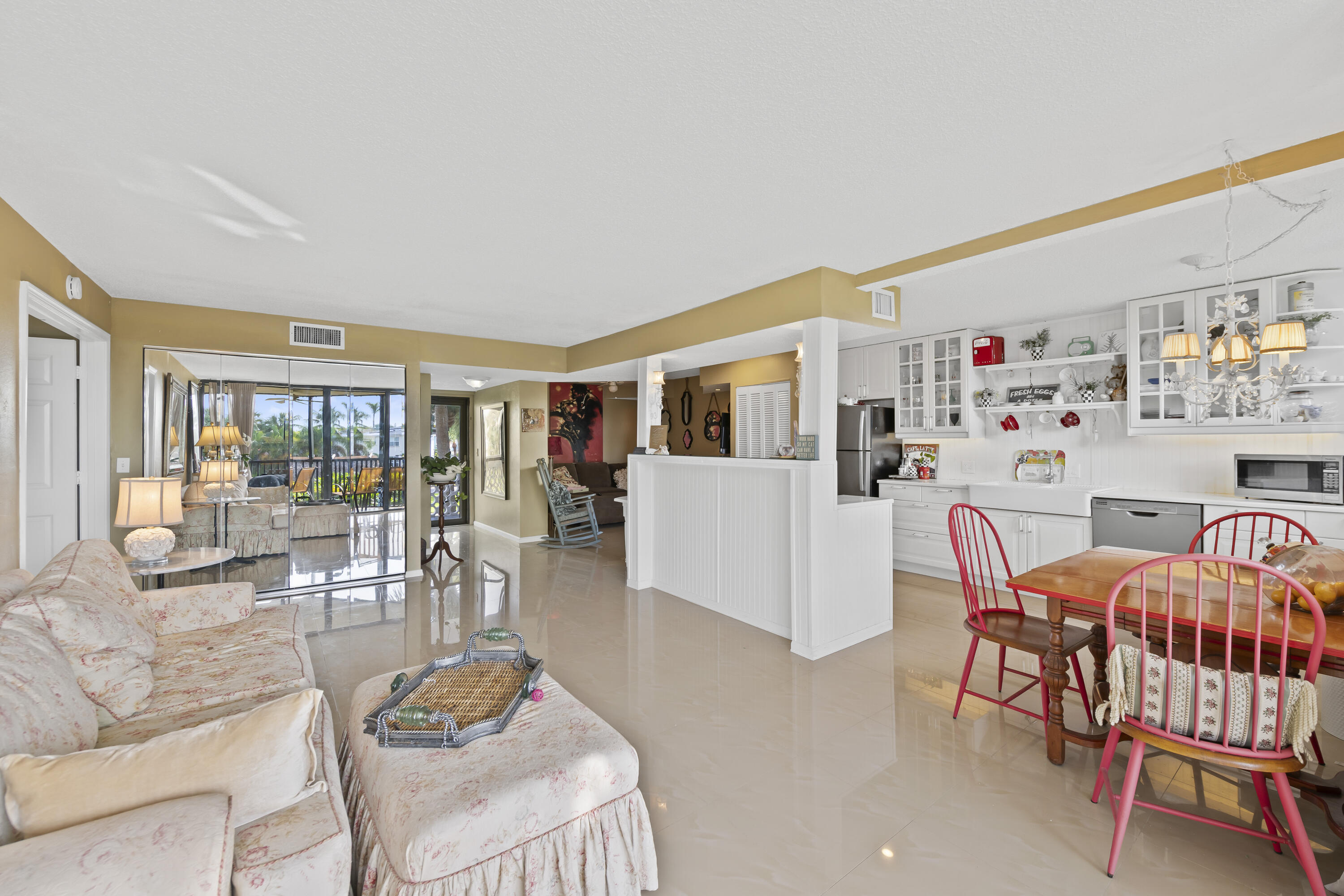 800 Jeffery Street, Unit 204 Boca Raton, FL 33487 - Photo 7 of 36 a living room with furniture and a dining table with floor to ceiling window
