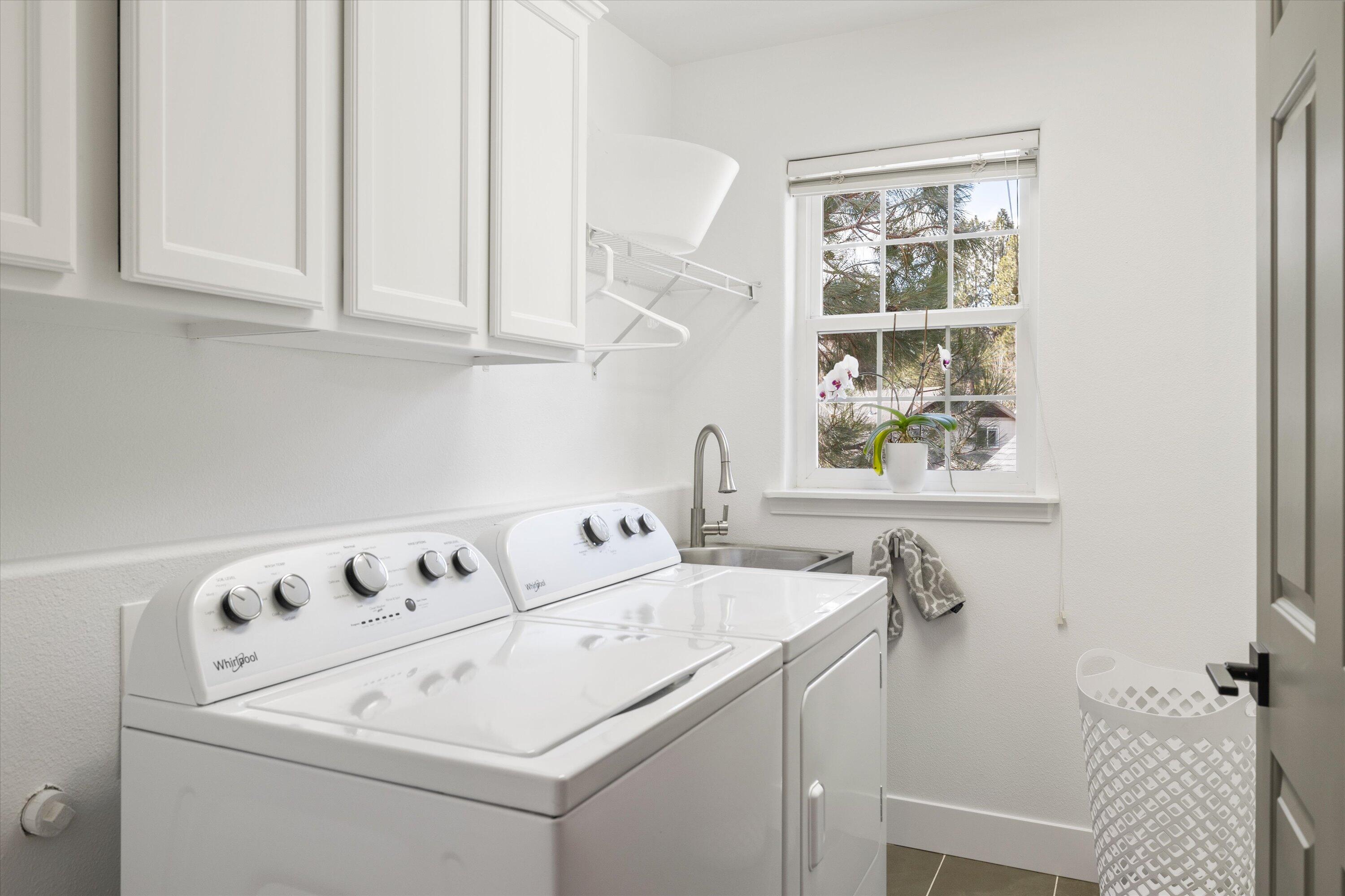 61269 Southwest Brookside Loop Bend, OR 97702 - Photo 28 of 46 Laundry Room with utility sink and storage cabinets