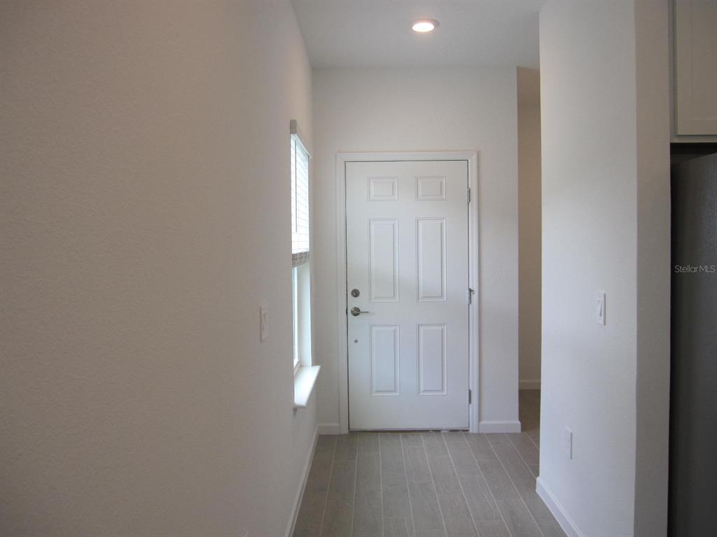4530 Northwest 14th Loop Ocala, FL 34482 - Photo 12 of 40 a view of a hallway with wooden floor