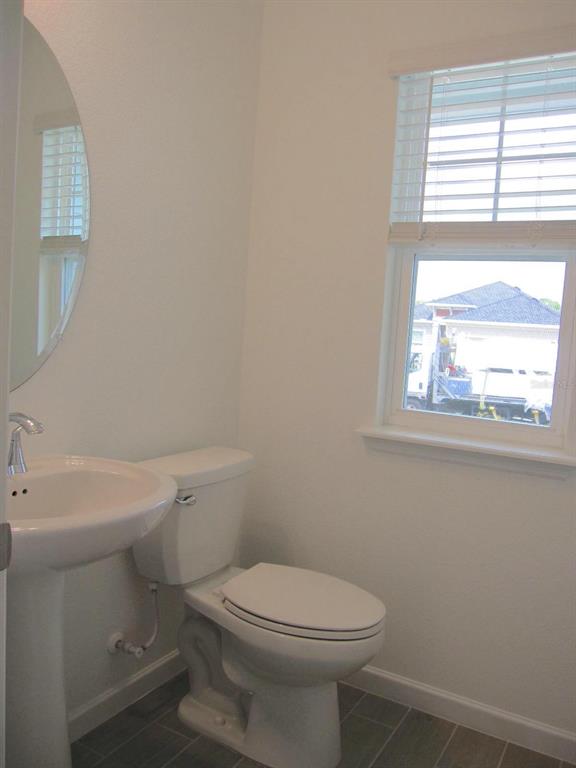 4530 Northwest 14th Loop Ocala, FL 34482 - Photo 15 of 40 a white toilet sitting next to a window in a bathroom