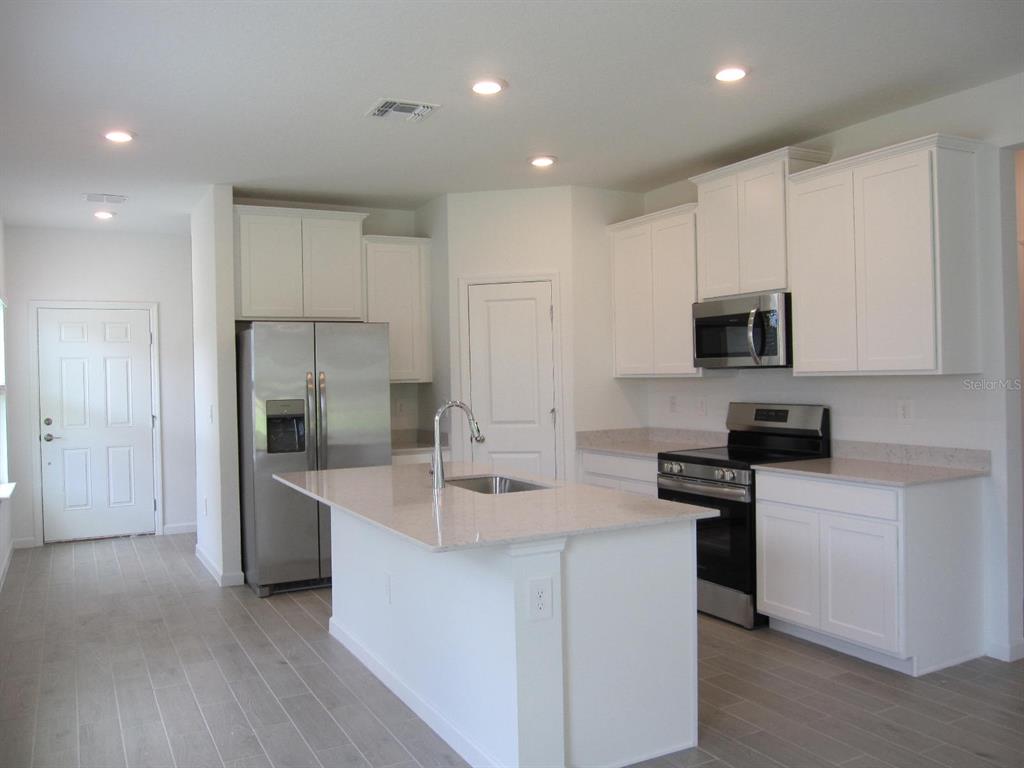 4530 Northwest 14th Loop Ocala, FL 34482 - Photo 20 of 40 a kitchen that has a sink and stainless steel appliances