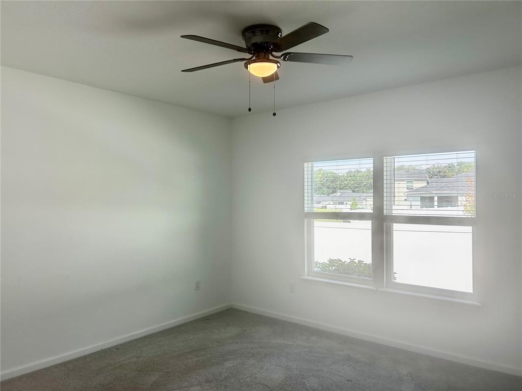4530 Northwest 14th Loop Ocala, FL 34482 - Photo 22 of 40 an empty room with a window and a fan