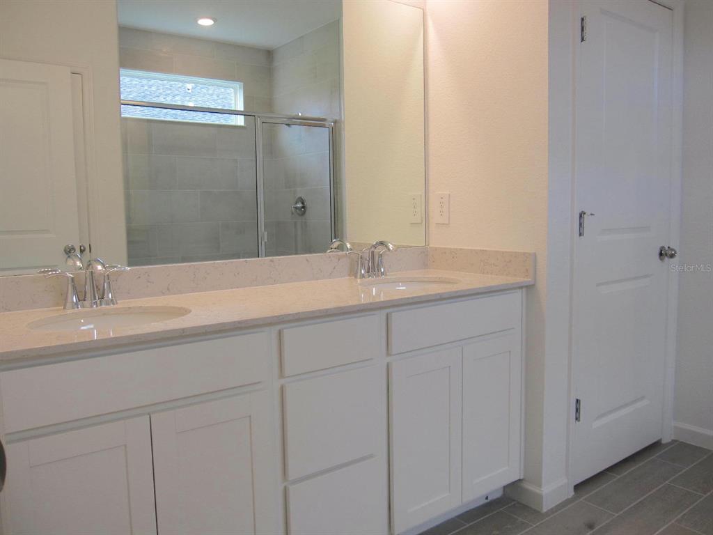 4530 Northwest 14th Loop Ocala, FL 34482 - Photo 25 of 40 a bathroom with a sink and a mirror