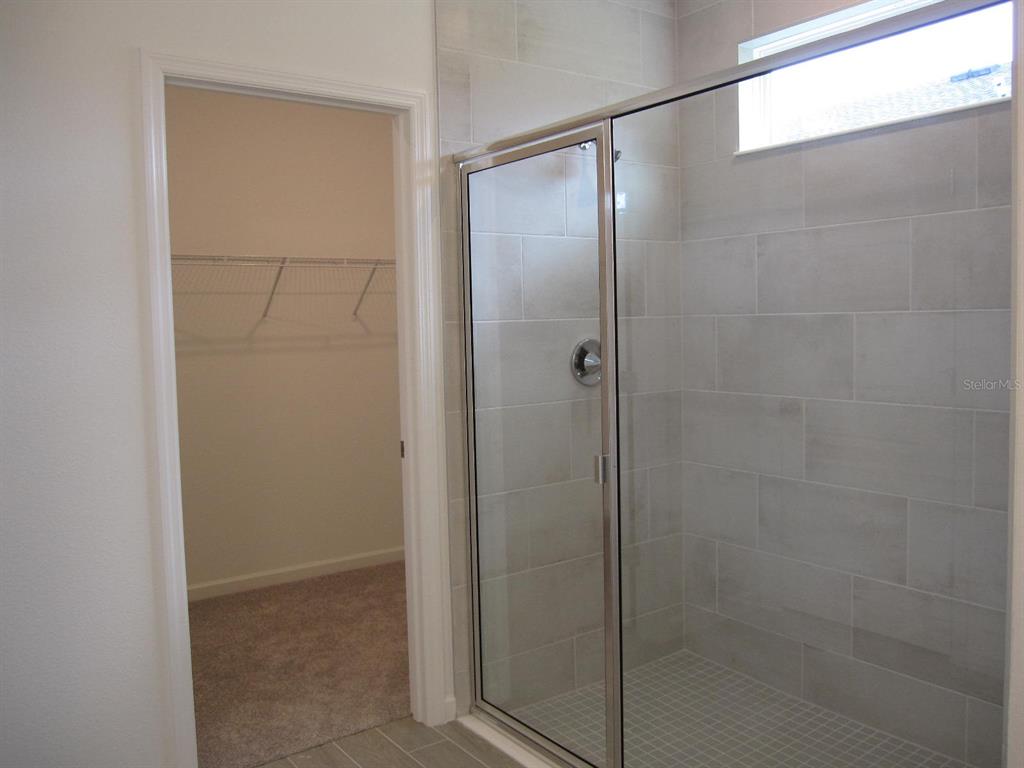 4530 Northwest 14th Loop Ocala, FL 34482 - Photo 28 of 40 a bathroom with a glass shower door
