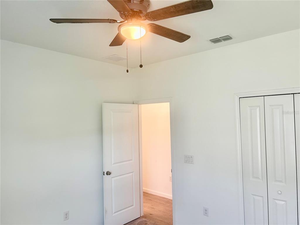 4530 Northwest 14th Loop Ocala, FL 34482 - Photo 32 of 40 an empty room with a ceiling fan and a fan