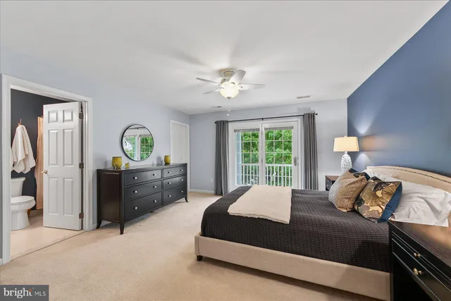 a bathroom with a sink vanity mirror and toilet