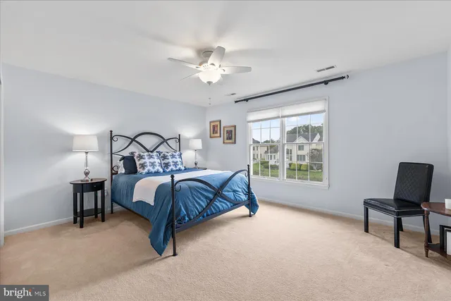 a bedroom with a bed a desk and chair