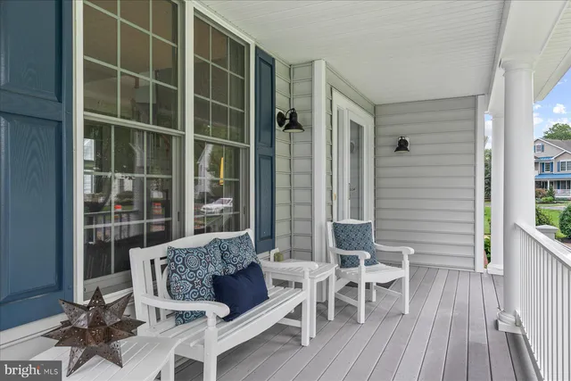 a living room with furniture a fireplace and a floor to ceiling window