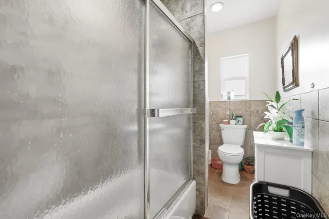 a bathroom with a granite countertop toilet a sink and a shower