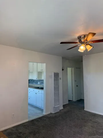 an empty room with closet and windows